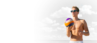 Person on beach wearing polarized sunglasses, ocean and sand in background